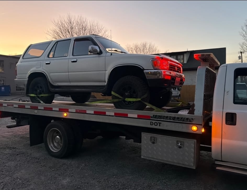 Older Toyota 4Runner loaded onto Dalo flatbed truck in Northern Virginia