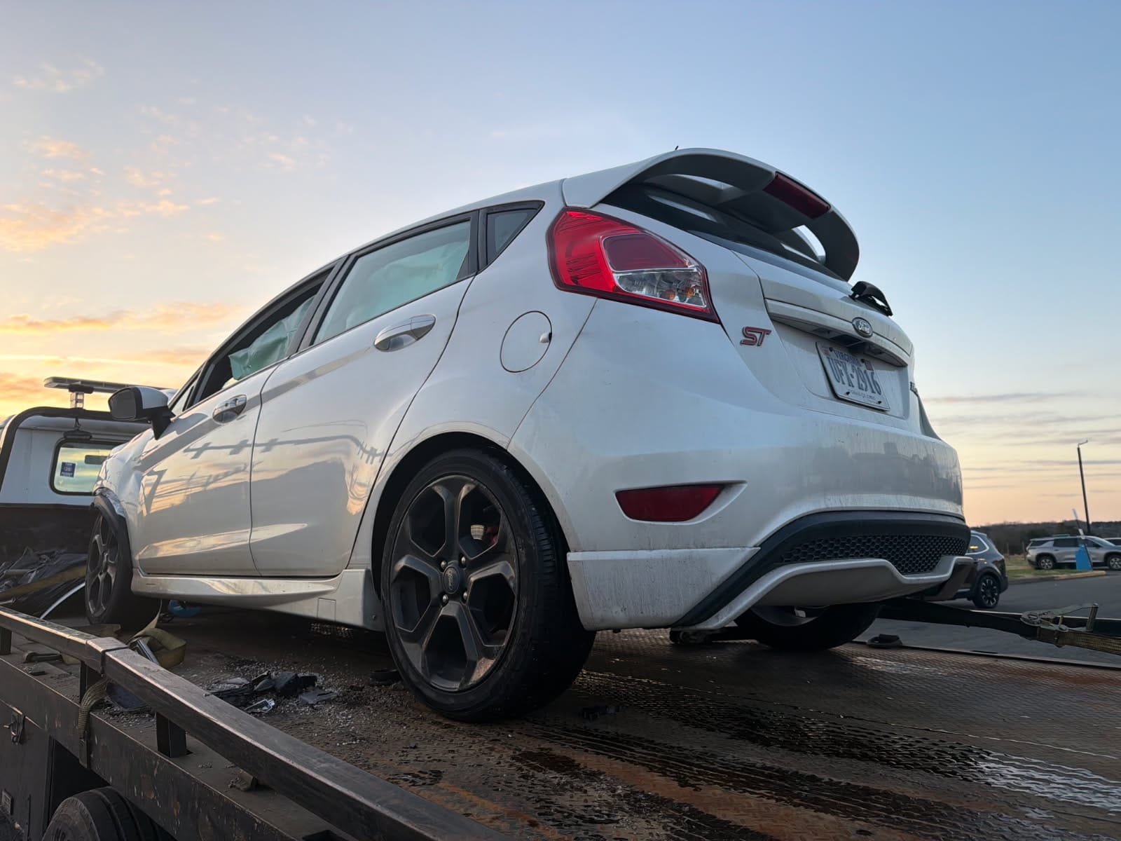 Commuter hatchback loaded onto a Dalo Auto Recycling flatbed truck in Fairfax County, VA