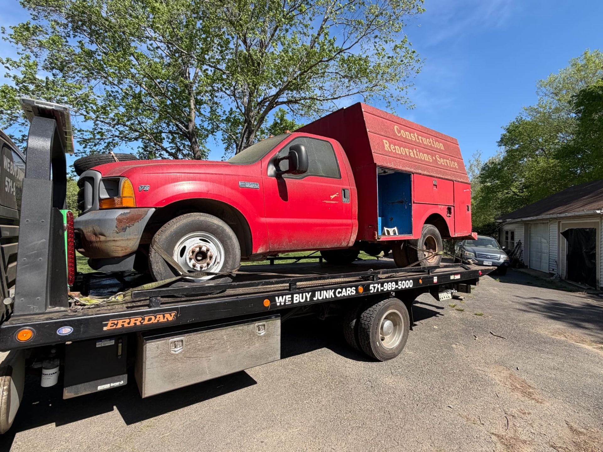 Work truck being removed by junk car tow truck in Virginia